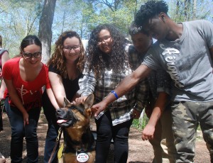 Giana, Francesca, Stephanie, Angel, and Freddie pose with a dog from the Paws 'N Effect program.