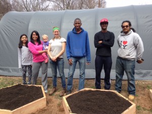 Common Ground students -- members of our School Garden Resource Center crew -- stand beside raised beds they've just constructed at a home-based child care provider. Health leadership among high school students lead to healthy eating among young children. 