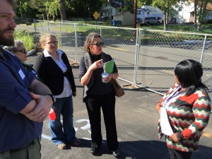 Dilias Ratchford talks with Common Ground staff next to the fence that separates New Haven from Hamden. 