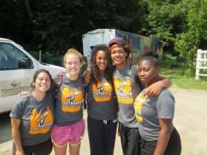 A diverse group of high school students from the Regional Environmental Council pose smiling.