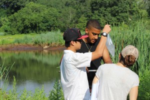 Common Ground student Loc Nguyen and recent graduate Michael Bruno work with Georgia Basso of the U.S. Fish and Wildlife Service to collect insect biodiversity data at New Haven’s West River Memorial Park.