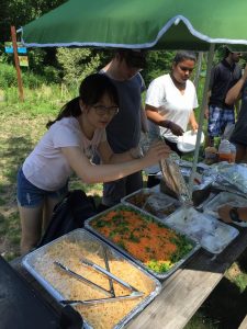 Huang Yi works with Common Ground's kitchen crew to prepare a lunch for other members of Common Ground's Green Jobs Corps and staff.