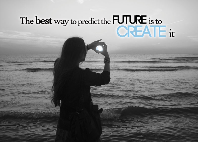 A young woman stands by the ocean and appears to hold the sun. The words "The Best way to predict the future is to create it" are written across the photo.